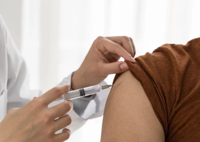 doctor vaccinating man doctor vaccinating man
